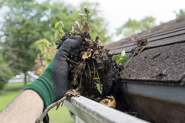 overflowing water, sagging gutters, and visible debris are all signs that gutter cleaning is necessary